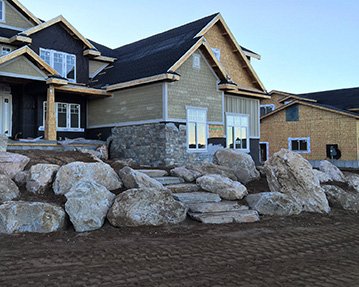 Rock stairs and landscaping in front of a house