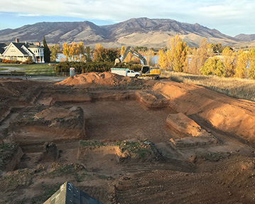 Large basement dug out with mountains in background