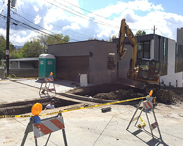 Small excavtor digging a trench for utilities