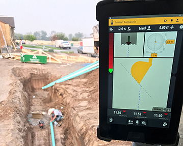 Excavator using trimble gps guidance to dig a trench for pipe