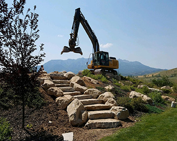 Rock stairs with excavator at top of stairs